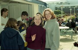 Open House 1998; two female students waving to camera in front of information booth [photograph 2...