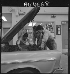 B.C. Vocational School image of an Instructor and Automotive Mechanics program students working o...