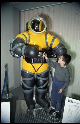 Open House 1998; boy holding hands with hard deep diving suit [photograph 2 of 2]