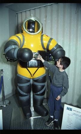 Open House 1998; boy holding hands with hard deep diving suit [photograph 1 of 2 ]
