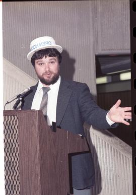 Open House 1986; man with open house hat gesturing to camera