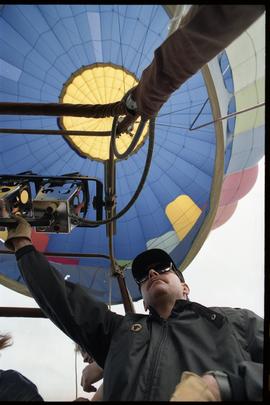 Open house 1992; man pulling lever in hot air balloon [photograph 2 of 3]
