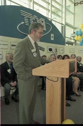 Open House 1998; bearded man speaking behind podium on Open House BCIT stage