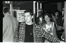 Communications Relations Opening Day 1991; student in flannel walking out of crowd through glass ...