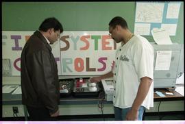 Open House 1998; student pointing to first system alarm display to man [photograph 4 of 4]