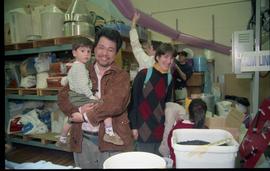 Open House 1998; family smiling for camera while standing in film supply studio