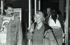 Communications Relations Opening Day 1991; woman staring at the camera in front of glass doors