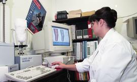 Woman viewing cast of residual limb and related detailed images on computer screen [3 of 3 photog...