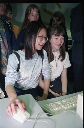 Open House 1998; two girls in front of computer, one using computer mouse [photograph 2 of 3]