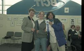 Open House 1998; two women pose with woman in suit while holding 1st place ribbon [photograph 3 o...
