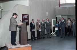 Open House 1986; man making speech on podium in front of crowd