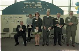 Open House 1998; woman standing with men on BCIT stage [photograph 1 of 2]