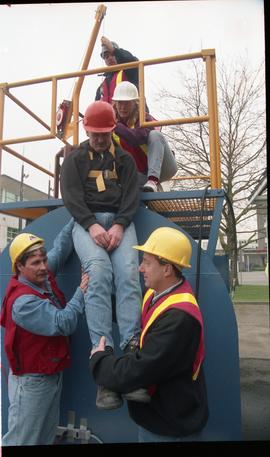 Open House 1998; four people assisting fifth man up on pulley harness [photograph 2 of 2]