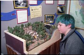 Open House 1998; child with teal hair observing 1st prize environmental display