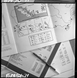 BCIT Business Management image of open documents on a desk with a pen sitting on top.