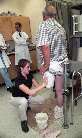 Cast being made of residual limb [3 of 3 photographs]