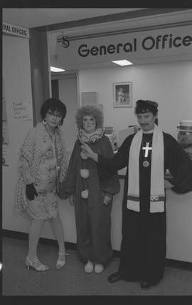 General Office staff dressed as a housewife (?), clown, and priest [3 of 11 photographs]