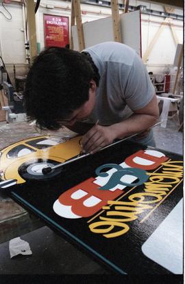 Open House 1986; man painting details  on car sign