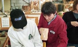 Trades discovery for women; carpentry, instructor (?) demonstrating tools to students inside a sh...