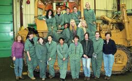 BCIT women in trades; heavy duty, students in uniforms standing in front of a bulldozer [2 of 9 p...