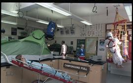 Open House 1986; outdoor gear display featuring first aid wheelbarrow
