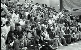 Communications Relations Opening Day 1991; crowd sitting on bleachers with papers in hand [photog...