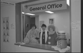 General Office staff dressed as a housewife (?), clown, and priest [11 of 11 photographs]