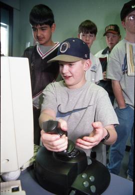Open House 1998; boy using joystick with computer