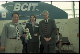 Open House 1998; two people stand with honorable mention ribbon with man in suit [photograph 1 of 2]