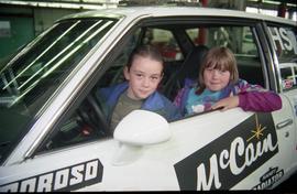 Open House 1998; two children sitting in driver's seat of McCain's racing car