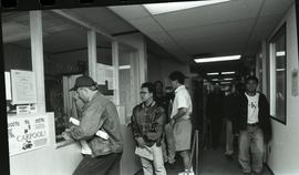 Communications Relations Opening Day 1991;  student in front of registration desk as others walk ...