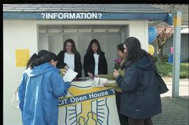 Open House 1998; group of women laugh and look over information kiosk papers [photograph 1 of 3]