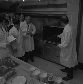 Hotel Motel Restaurant Administration Program; instructor showing students a grill