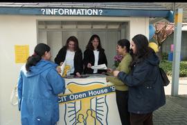 Open House 1998; group of women laugh and look over information kiosk papers [photograph 3 of 3]