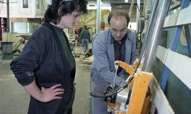 BCIT Women in Trades; carpentry, two people looking at machine