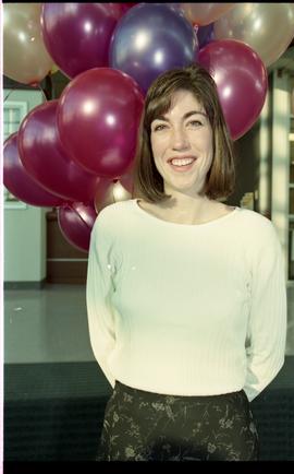 Open house 1995; woman  smiling in front of balloons [photograph 2 of 4 ]