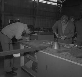 Sheet metal, 1968; student use scissors to cut sheet metal ; student measuring a piece of sheet m...