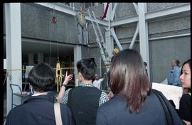 Open House 1998; group watches demonstration with dummy  in harness hanging from above crowd [pho...