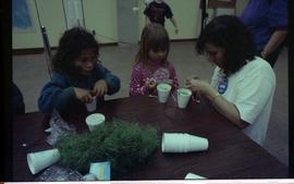 Open house 1992; two girls and woman making crafts with fake grass and cups [photograph 1 of 2]