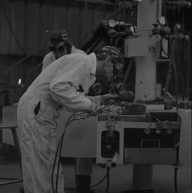 Welding, 1968; man wearing protective goggles welding ; welding equipment in background ; man wor...