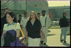 Open House 1998; students passing by energy building with focus on one student