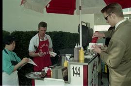 Open House 1998; man with tongs behind Mr. Tube food cart