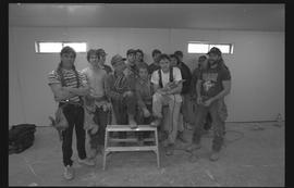 Students holding power tools and posing for a group shot during gym construction [8 of 8 photogra...