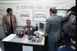Open House 1986; man explaining computer aided management to group [photograph 2 of 2]