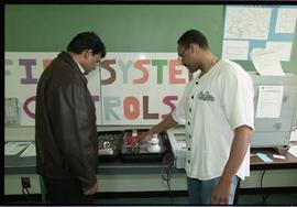 Open House 1998; student pointing to first system alarm display to man [photograph 1 of 4]