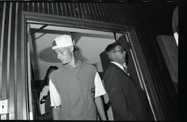 Communications Relations Opening Day 1991; man in backwards baseball cap and man in suit facing a...