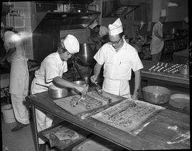 BC Vocational School Cook Training Course ; two students glazing pastry desserts ; students worki...