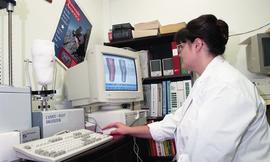 Woman viewing cast of residual limb and related detailed images on computer screen [2 of 3 photog...