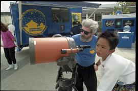 Open house 1992; man explaining Schmidt–Cassegrain telescope to child