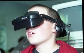 Open House 1998; close up right hand view of boy on VR headset